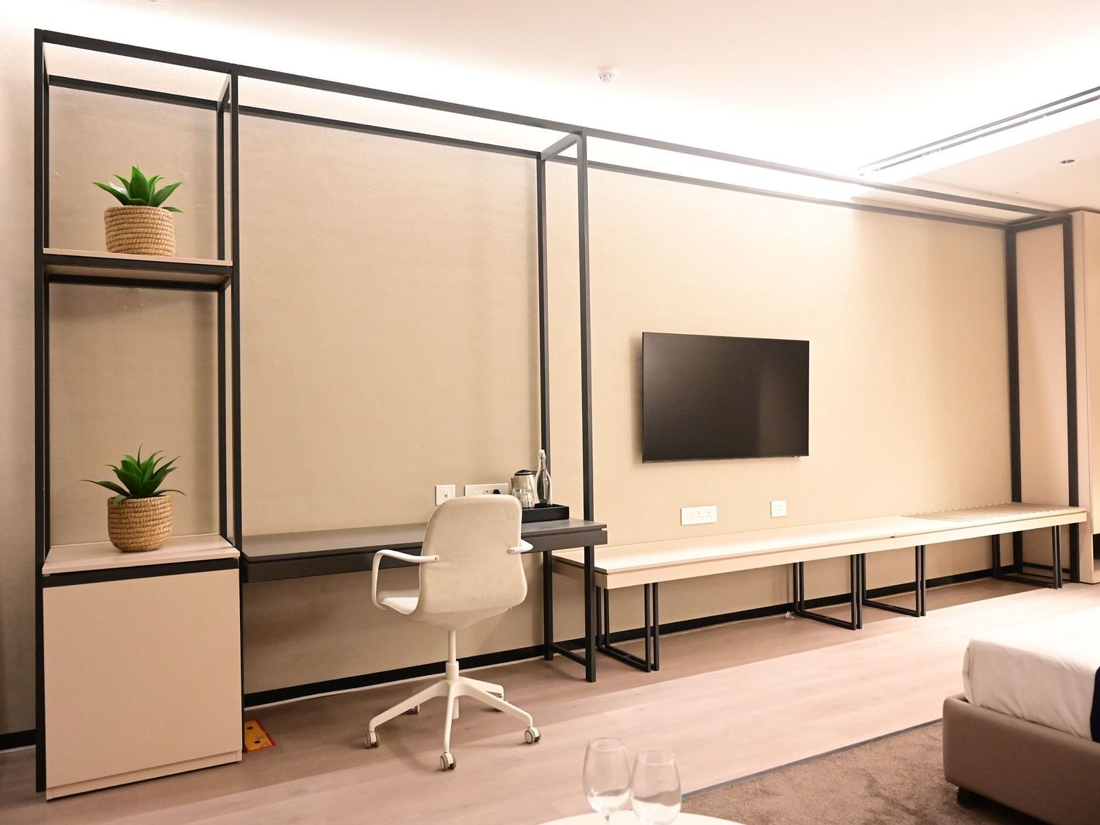 image featuring a work desk along with a wall mounted television in a room at club charholi, pune